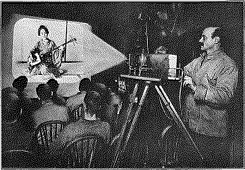 A guy rooling the old projector.