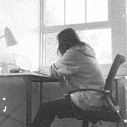 a gif of a women working on something next to the window on a laptop.